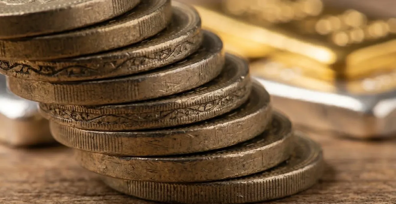 Macro shot of British pound coins with defensive investment symbols