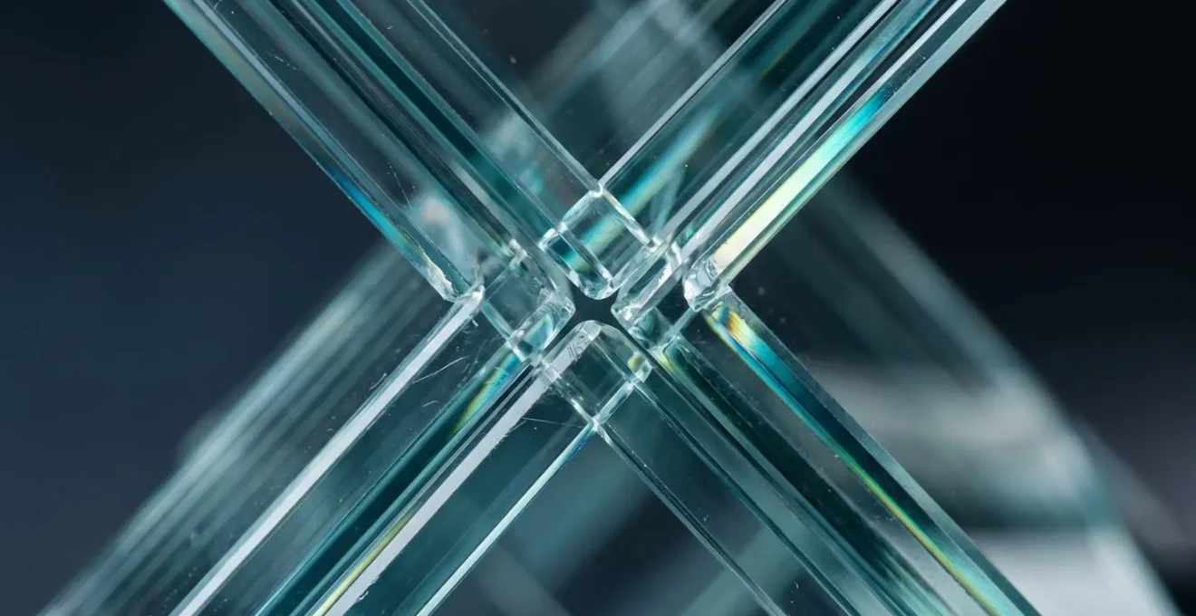 Macro photograph of overlapping glass panels creating protective layers, symbolizing multiple insurance coverage levels